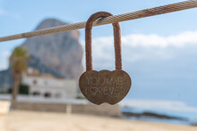 Close-up Of A Rust Padlock Where You Can Read -You And Me Forever-, With A Blurred Background.