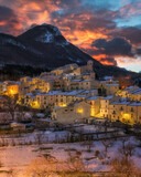 Fototapeta Perspektywa 3d - The beautiful village of Civitella Alfedena, covered in snow at sunset during winter season. Province of L'Aquila, Abruzzo, Italy.