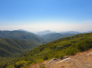 Sticker - Mesmerizing view of mountains covered with bushes under a blue clear sky