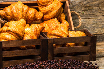 Sticker - Closeup shot of fresh-baked French croissants in a wooden box