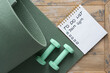 © Marina - Notepad on the wooden background with the inscription - To do list - Join gym.