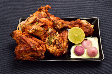 Wall Mural - Chicken Tandoori with chutney, lemon and onion in plate