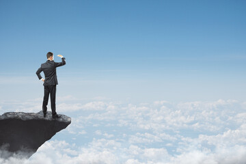 Wall Mural - abstract image of businessman looking into the distance while standing on edge of cliff, mock up pla