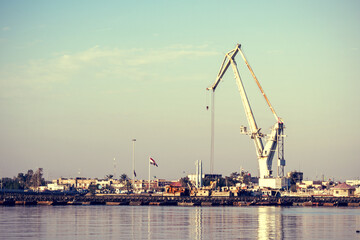 Sticker - Landscape of a harbour surrounded by cranes on a sunny day in Basrah, Iraq