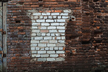 Old Wall With Peeling Stucco. Damaged Plaster On Red Brick Wall Background.