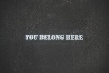 "you Belong Here" Painted Text On The Road