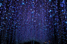 Tunnel Light Garland On A Transparent,Christmas Background With Crystal Lights.LED Lights Garland Or Many Small Lantern Festival, Lighting Bulbs Decorated To Curtain Lamp On A Bokeh With Dark Night.