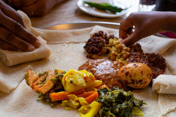 Vegetarian Injera meal with shiro, lentils and egg