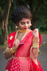 Canvas Print - Beautiful Indian girl in a bridal costume with red saree and makeup