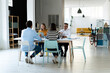 © Westend61 - Colleagues sitting at desk working in office