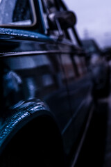 Wall Mural - Closeup of an old blue Soviet Union car covered in rain droplets