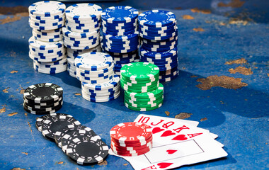 Sticker - Closeup of poker chips and playing cards on a rough blue surface