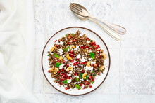 Studio Shot Of Plate Of Quinoa Salad With Feta Cheese, Pomegranate Seeds And Cashews