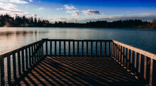Wooden Bridge Or A Pier Over The Lake In The Morning