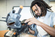 © Westend61 - Technician with braided hair working with combat tank at workshop