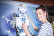 © Westend61 - Smiling engineer with screwdriver near human robot in workshop