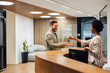 © bnenin - Happy adult executive, greeting the african-american receptionis.