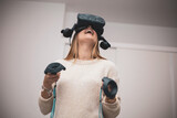 Fototapeta Sypialnia - a girl undergoes vision therapy with virtual reality glasses at an optician.