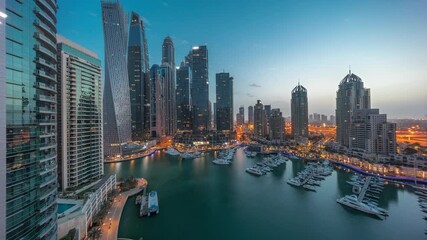 Wall Mural - Dubai marina tallest skyscrapers and yachts in harbor aerial night to day timelapse.