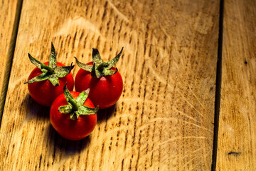 Sticker - Cherry tomatoes on a rustic wooden background with a copy space