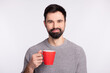 © Tetiana - Photo of handsome guy enjoy morning coffee break cup drink rest cappuccino isolated on grey color background