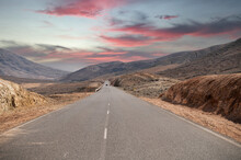 Empty Asphalt Road In Mountainous Terrain