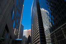 Skyscrapers Of San Francisco And Reflections In Windows Against The Blue Sky