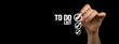 © FellowNeko - To do list with checklist boxes. Hand marking with pen on a black background, banner photo
