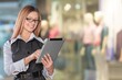 © BillionPhotos.com - Clothing Store, Female Visual Merchandising Professional Uses Tablet Computer