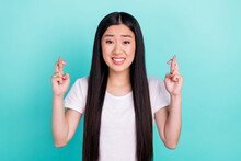 Photo Of Young Asian Girl Worried Crossed Fingers Wish Beg Luck Success Isolated Over Teal Color Background