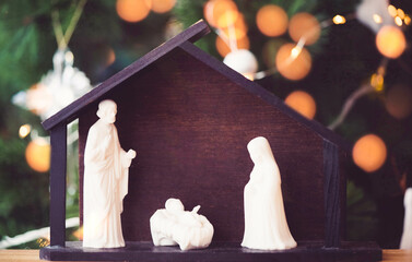 Wall Mural - Christmas nativity scene of born child baby Jesus Christ in the manger with Joseph and Mary.Traditional Christmas advent Nativity Scene Jesus in the manger on bokeh background.christian nativity scene