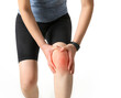 © Choi_ Nikolai - A woman in sportswear is holding a painful knee joint (marked in red)