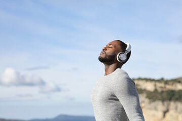 Wall Mural - Man with black skin meditating listening audio guide