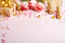 Pink Roses Flowers, Champagne, Gift, Golden Ribbons And Confetti Red Hearts On Pink Background. Top View Flat Lay With Space For Your Greetings. Valentines Day Background And Greeting Card.