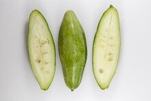 Top View Of Unripe Healthy Organic Fresh Pointed Gourds Cut In Half Isolated On A White Background