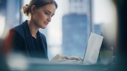 Aufkleber - Close Up Portrait of a Successful Businesswoman Working on Laptop in Open Office with Colleague, Confident Female CEO Analyze Financial Projects. Manager at Work Planning Marketing Campaign.
