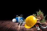 Fototapeta Sypialnia - Construction hard hat and plumbing items with Christmas and New Year decoration over holiday background.