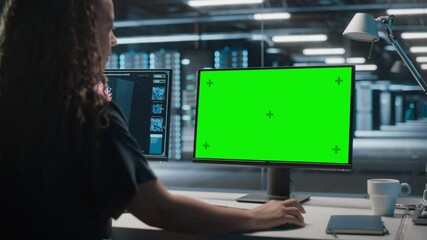 Wall Mural - High-Tech Data Center Server: Black Female IT Specialist Working on Green Screen Chroma Key Computer. Monitoring Web Services, Cloud Computing, Analytics Facility, Maintenance of Cyber Security