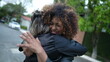 © Marco - Girlfriends embrace and hug. Two diverse women hugging outside