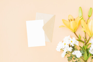 Wall Mural - mockup white wedding invitation and envelope with yellow lilies on color background