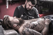 © Mr. Prof - Master tattooist demonstrates the process of getting tattoo
