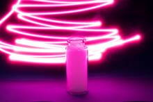 Smoke In A Small Glass Container On A Background Of Neon Red Lines, Nicotine In A Glass Container