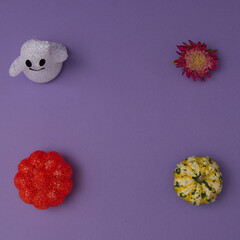 Sticker - Halloween decoration with pumpkin and flower on a purple background