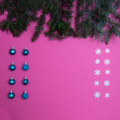 Canvas Print - Trees with snowflakes and Christmas tree decorations on a pink background with copy space