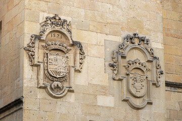 Wall Mural - Coat of arms in Segovia Cathedral. Left is Philip II of Spain. Right is the council of canons