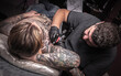 © Mr. Prof - Tattooist and his customer in the workshop