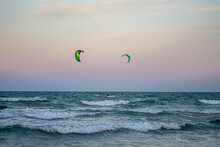 Windsurfing At Sunset On A Cullera Beach. Calm Sea And Vivid Colors In The Sky