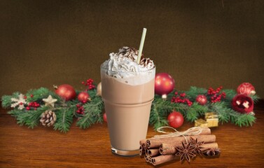 Poster - Hot drink with marshmallows in a mug. Fir cones, spices in the background.