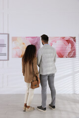 Wall Mural - Couple at exhibition in art gallery, back view