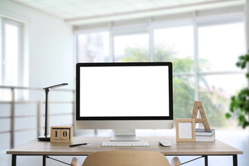 Workplace with modern computer on wooden table indoors. Mockup for design